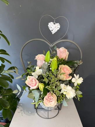 Stunning scented design with roses, freesias and lily arranged in wicker metal heart pot which can be reused as a porch planter. Perfect gift for Mother’s Day by florist in Hayes, Bromley, Kent