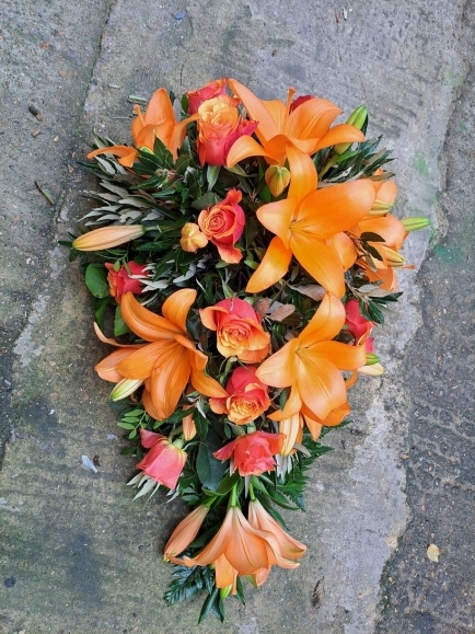 classic rose and lily teardrop spray in orange colours made by florist in Bromley for delivery in Bromley area, Kent, UK