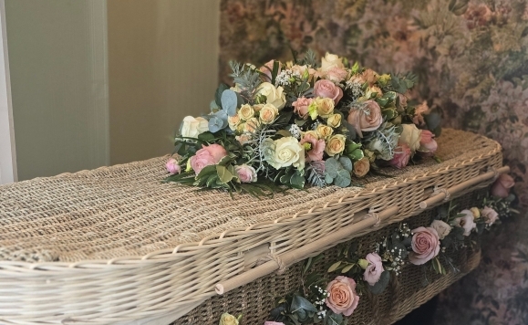 Silver eternity funeral coffin spray with blush pink roses, lisianthus, spray roses and Gypsophilium finished with silver eucalyptus and acacia