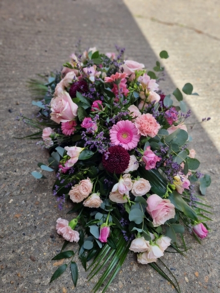 soft pink roses and spray roses coffin with burgundy blooms, eucalypthus and limonium made by florist in  Hayes, Bromley