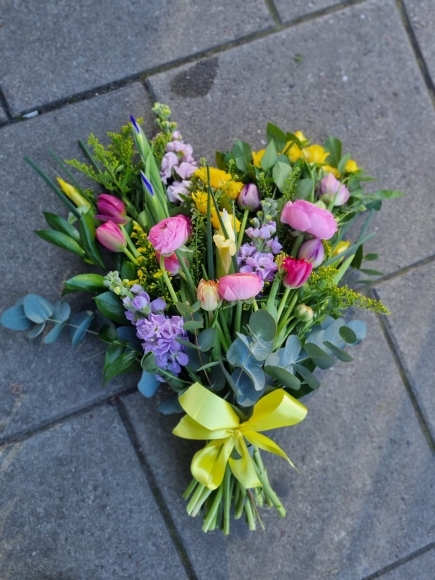 Mixed colours spring sheaf to include tulips, rununculus, stock, solidago, iris and eucalypthus. Please notice spring flowers are shorter and sheaf is petit. By Blooms and Candy Florist