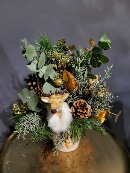 Elegant arrangement with Christmas foliages and winter decorations to include stag head. All nicely presented in ceramic stag pot for lovely display. Arrangement is approximately 50cm tall. Made by local independent flower shop in Bromley, Kent, UK for guaranteed Christmas delivery in all BR postcodes