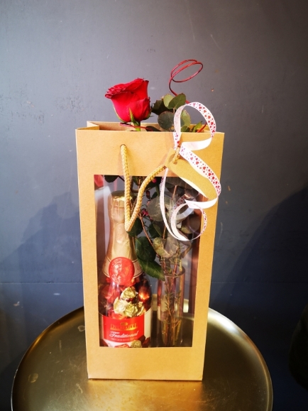 Single red rose in a bid vase with truffle chocolate bottle made by florist in Bromley, Hayes for Valentine's