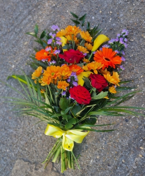 Florist choice of flowers in vibrant shade. Please let us know if you want or not Lilies to be included. By Blooms and Candy funeral florist Bromley